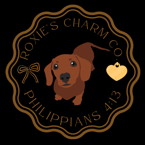 Logo of Roxie's Charm Co with a dachshund and heart tag on a black background